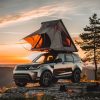 Rooftop tent for camping on top of high mountain at sunset