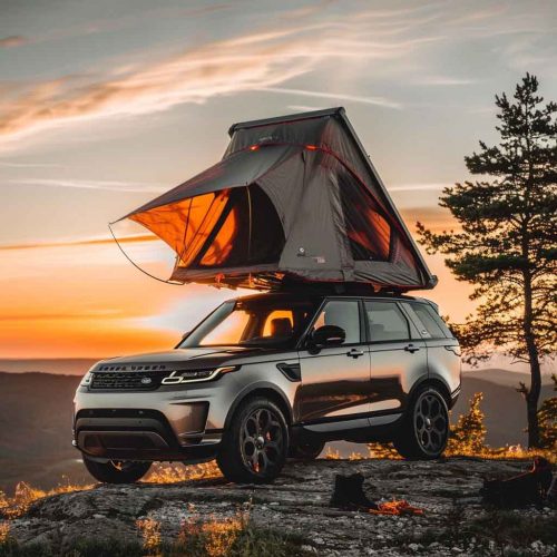 Rooftop tent for camping on top of high mountain at sunset