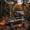 Wild camping, roof tent blends into nature and enjoys peaceful time