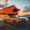 Rooftop tent camping on the beach under the setting sun