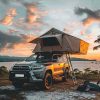 Rooftop tent camping on the beach under the sunset