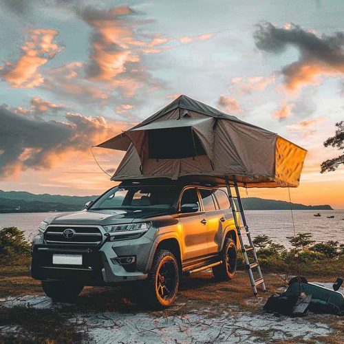 Rooftop tent camping on the beach under the sunset